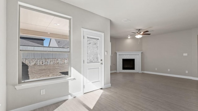 11213 Orchard Ln, Justin, TX 76247 - unfurnished living room with ceiling fan, a fireplace, baseboards, and wood finished floors