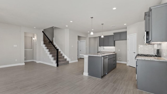 11213 Orchard Ln, Justin, TX 76247 - kitchen with appliances with stainless steel finishes, a sink, tasteful backsplash, recessed lighting, and an island with sink