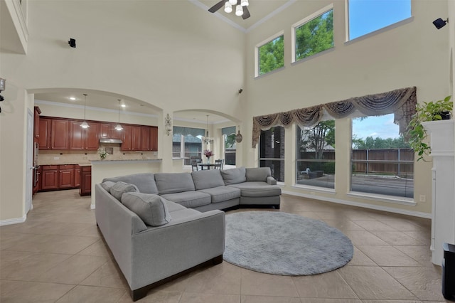 621 Maize Rd, Murphy, TX 75094 - living area with crown molding, arched walkways, high vaulted ceiling, light tile patterned floors, and ceiling fan