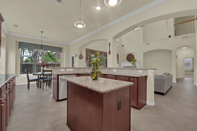 621 Maize Rd, Murphy, TX 75094 - kitchen with stainless steel dishwasher, a center island, arched walkways, light tile patterned flooring, and ornamental molding