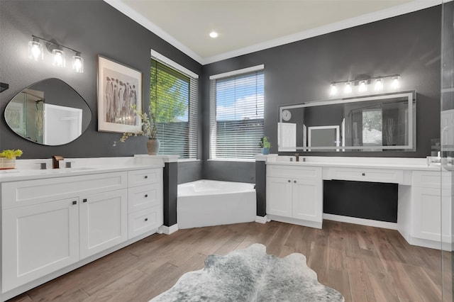 621 Maize Rd, Murphy, TX 75094 - bathroom with a bath, two vanities, ornamental molding, and wood finished floors