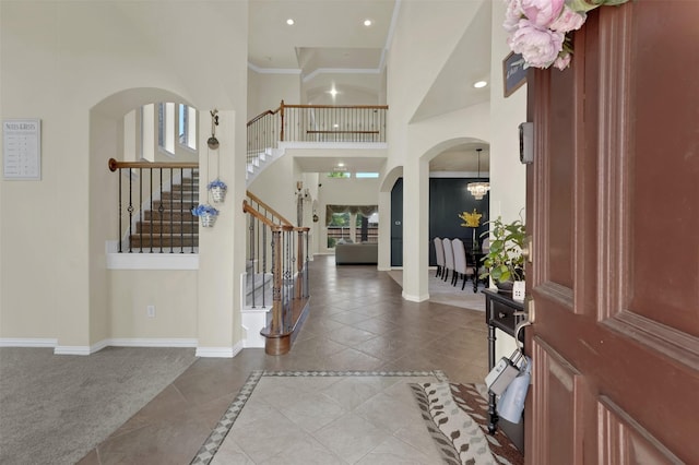 621 Maize Rd, Murphy, TX 75094 - tiled entryway featuring stairway, a high ceiling, arched walkways, baseboards, and a chandelier