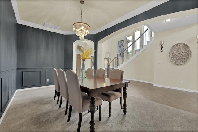 621 Maize Rd, Murphy, TX 75094 - dining area with arched walkways, stairs, a decorative wall, a chandelier, and carpet
