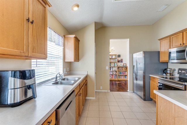 2401 Loon Lake Rd, Denton, TX 76210 - kitchen with appliances with stainless steel finishes, a sink, light countertops, light tile patterned floors, and baseboards