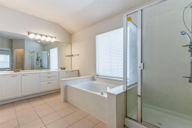 2401 Loon Lake Rd, Denton, TX 76210 - full bathroom with a shower stall, double vanity, a bath, tile patterned floors, and vaulted ceiling
