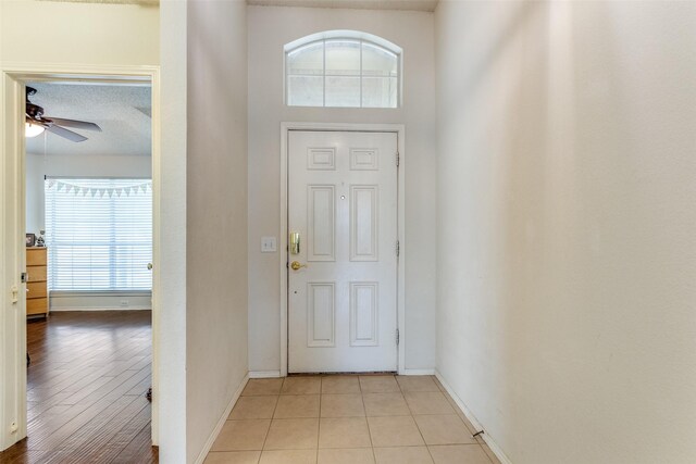 2401 Loon Lake Rd, Denton, TX 76210 - entryway with baseboards, ceiling fan, a textured ceiling, and light tile patterned floors