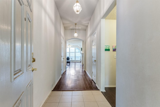 2401 Loon Lake Rd, Denton, TX 76210 - hall featuring arched walkways, baseboards, and tile patterned flooring