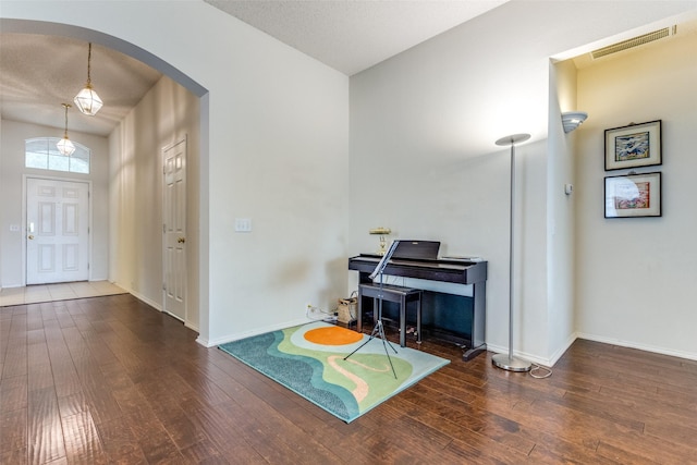2401 Loon Lake Rd, Denton, TX 76210 - foyer featuring arched walkways, wood-type flooring, and baseboards