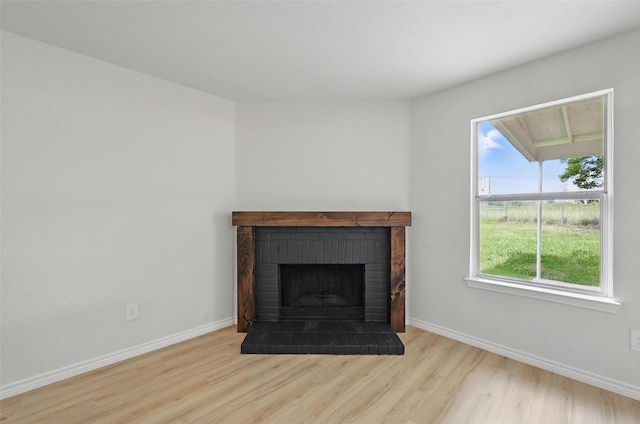 1126 Mazourka Dr, Arlington, TX 76001 - detailed view of wood finished floors, a brick fireplace, and baseboards