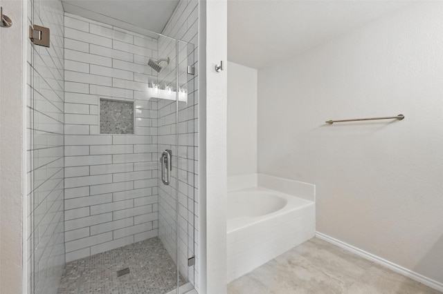 1126 Mazourka Dr, Arlington, TX 76001 - bathroom featuring a stall shower, a bath, and baseboards