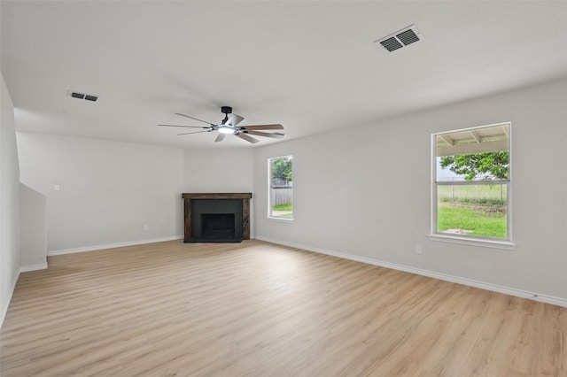 1126 Mazourka Dr, Arlington, TX 76001 - unfurnished living room with a fireplace, light wood-style flooring, baseboards, and a ceiling fan