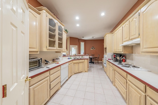 8300 Red Rose Trl, North Richland Hills, TX 76182 - kitchen with white appliances, light brown cabinetry, under cabinet range hood, a sink, and a peninsula