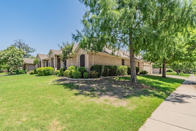 8300 Red Rose Trl, North Richland Hills, TX 76182 - view of front of property with brick siding and a front yard