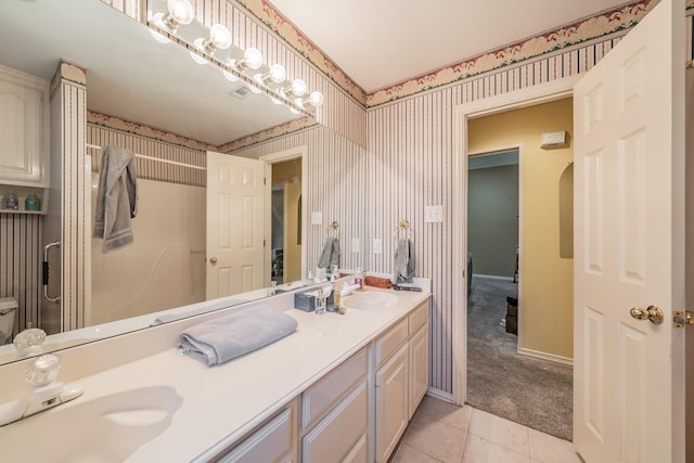 8300 Red Rose Trl, North Richland Hills, TX 76182 - full bathroom featuring double vanity, wallpapered walls, tile patterned floors, and baseboards