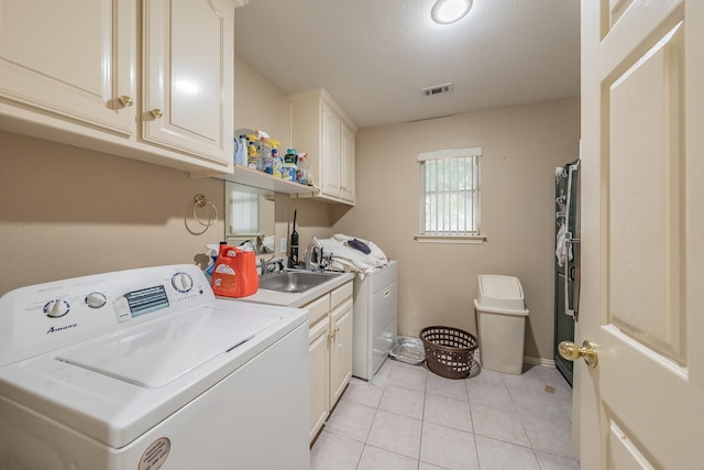 8300 Red Rose Trl, North Richland Hills, TX 76182 - laundry area featuring cabinet space, light tile patterned floors, separate washer and dryer, and baseboards
