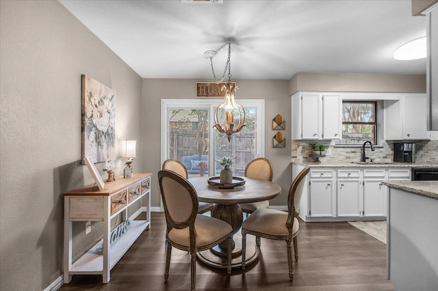 1210 Kay Dr, Weatherford, TX 76086 - dining room featuring dark wood finished floors and baseboards