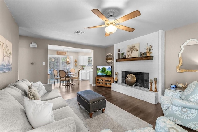 1210 Kay Dr, Weatherford, TX 76086 - living area featuring a fireplace, wood finished floors, and a ceiling fan