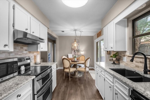 1210 Kay Dr, Weatherford, TX 76086 - kitchen with appliances with stainless steel finishes, under cabinet range hood, a sink, baseboards, and white cabinets