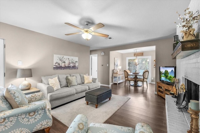 1210 Kay Dr, Weatherford, TX 76086 - living room with dark wood-style flooring, baseboards, a ceiling fan, and a fireplace