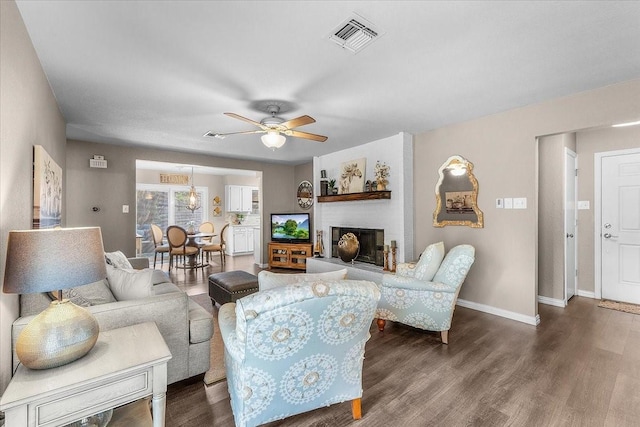 1210 Kay Dr, Weatherford, TX 76086 - living area with baseboards, wood finished floors, ceiling fan, and a fireplace