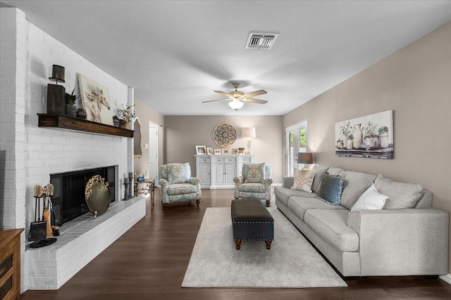 1210 Kay Dr, Weatherford, TX 76086 - living room with dark wood-type flooring, a brick fireplace, and ceiling fan