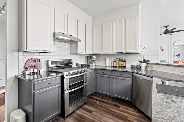 4932 Glenscape Trl, Fort Worth, TX 76137 - kitchen featuring gray cabinets, appliances with stainless steel finishes, under cabinet range hood, light stone countertops, and decorative backsplash