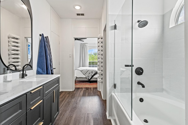 4932 Glenscape Trl, Fort Worth, TX 76137 - bathroom with double vanity, wood finished floors, bathtub / shower combination, ensuite bathroom, and baseboards