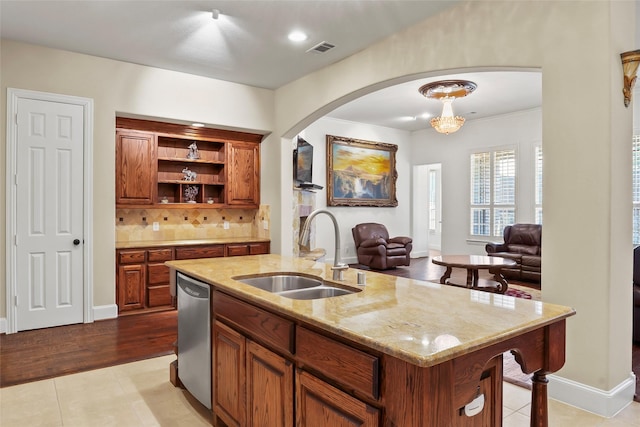 4211 Wilson Creek Trl, Prosper, TX 75078 - kitchen featuring a sink, stainless steel dishwasher, arched walkways, a kitchen island with sink, and open floor plan