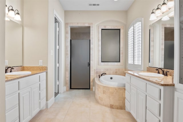 4211 Wilson Creek Trl, Prosper, TX 75078 - full bathroom featuring two vanities, healthy amount of natural light, and a bath