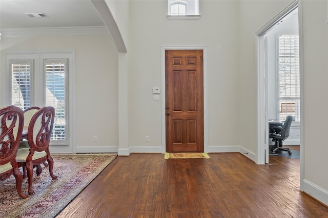4211 Wilson Creek Trl, Prosper, TX 75078 - entryway featuring arched walkways, dark wood-style floors, plenty of natural light, and crown molding