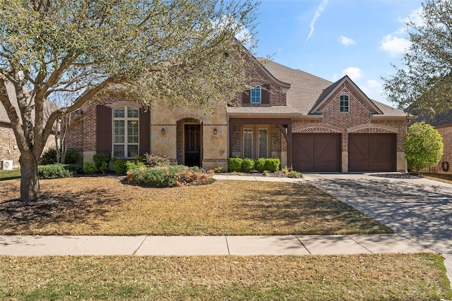 4211 Wilson Creek Trl, Prosper, TX 75078 - view of front of property with concrete driveway, a garage, brick siding, and stone siding
