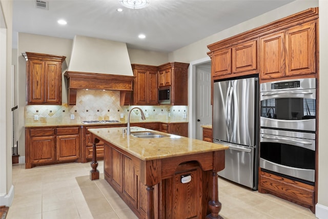 4211 Wilson Creek Trl, Prosper, TX 75078 - kitchen with appliances with stainless steel finishes, a sink, custom exhaust hood, light stone countertops, and brown cabinetry