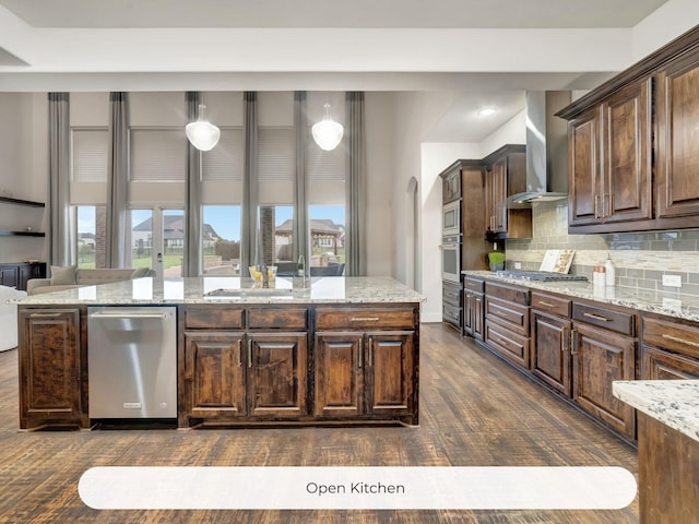 4603 Whitestone Dr, Parker, TX 75002 - kitchen with wall chimney range hood, stainless steel appliances, a center island, dark wood-style floors, and tasteful backsplash
