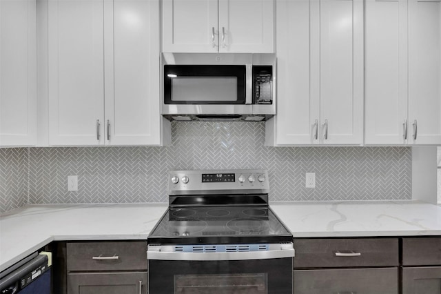 7401 Trimble Dr, Fort Worth, TX 76134 - kitchen with appliances with stainless steel finishes, white cabinetry, decorative backsplash, light stone counters, and dark brown cabinets