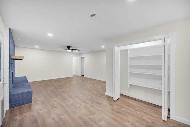7401 Trimble Dr, Fort Worth, TX 76134 - unfurnished living room with a ceiling fan, recessed lighting, wood finished floors, a brick fireplace, and baseboards