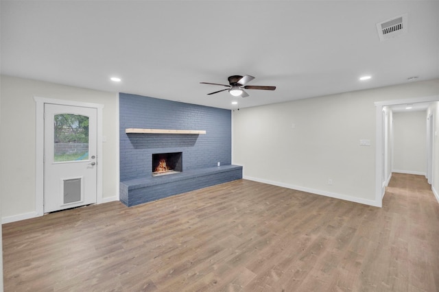 7401 Trimble Dr, Fort Worth, TX 76134 - unfurnished living room featuring ceiling fan, wood finished floors, a fireplace, recessed lighting, and baseboards