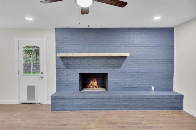 7401 Trimble Dr, Fort Worth, TX 76134 - unfurnished living room featuring wood finished floors, a brick fireplace, baseboards, ceiling fan, and recessed lighting