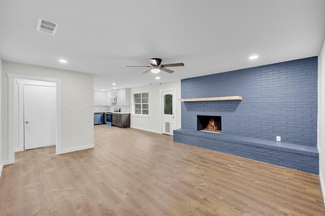 7401 Trimble Dr, Fort Worth, TX 76134 - unfurnished living room featuring ceiling fan, light wood finished floors, a fireplace, recessed lighting, and baseboards