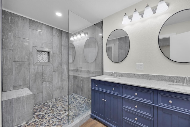 7401 Trimble Dr, Fort Worth, TX 76134 - bathroom featuring double vanity, walk in shower, wood finished floors, and recessed lighting
