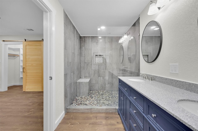 7401 Trimble Dr, Fort Worth, TX 76134 - full bathroom featuring double vanity, walk in shower, wood finished floors, recessed lighting, and baseboards