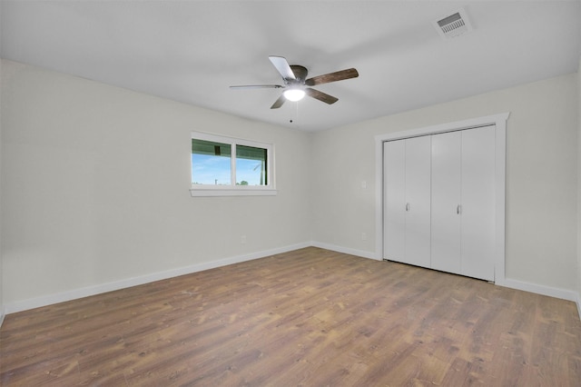 7401 Trimble Dr, Fort Worth, TX 76134 - unfurnished bedroom featuring wood finished floors, baseboards, ceiling fan, and a closet