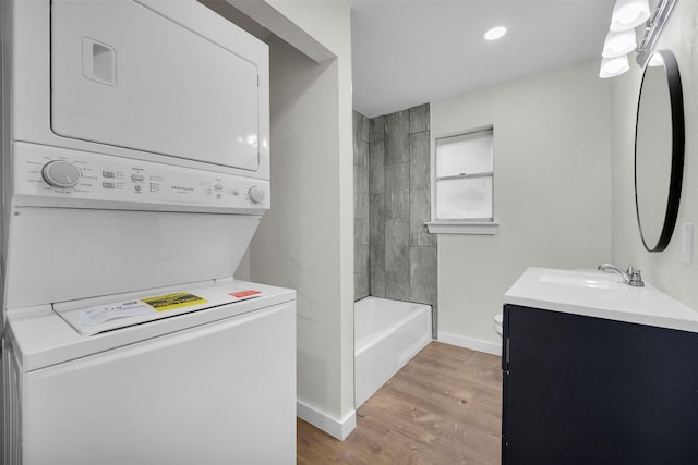 7401 Trimble Dr, Fort Worth, TX 76134 - bathroom featuring stacked washer / dryer, vanity, baseboards, toilet, and wood finished floors