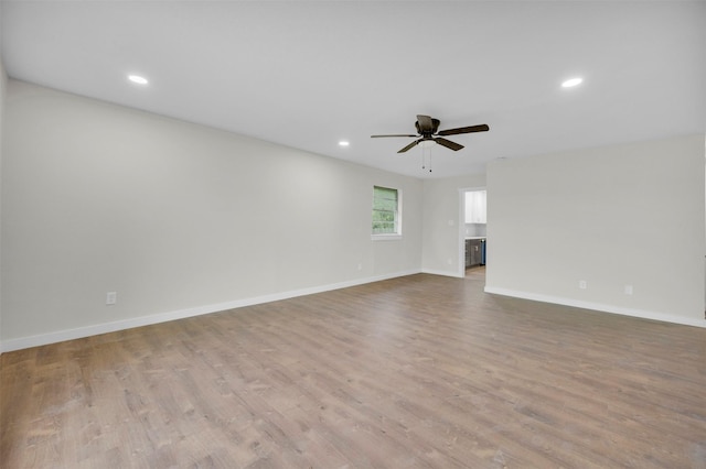 7401 Trimble Dr, Fort Worth, TX 76134 - unfurnished living room featuring a ceiling fan, recessed lighting, light wood finished floors, and baseboards