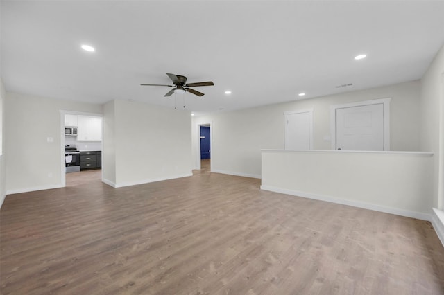 7401 Trimble Dr, Fort Worth, TX 76134 - unfurnished living room with ceiling fan, baseboards, wood finished floors, and recessed lighting
