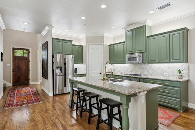 828 Lake Vista Pl, Coppell, TX 75019 - kitchen with green cabinets, stainless steel appliances, a sink, a kitchen island with sink, and recessed lighting