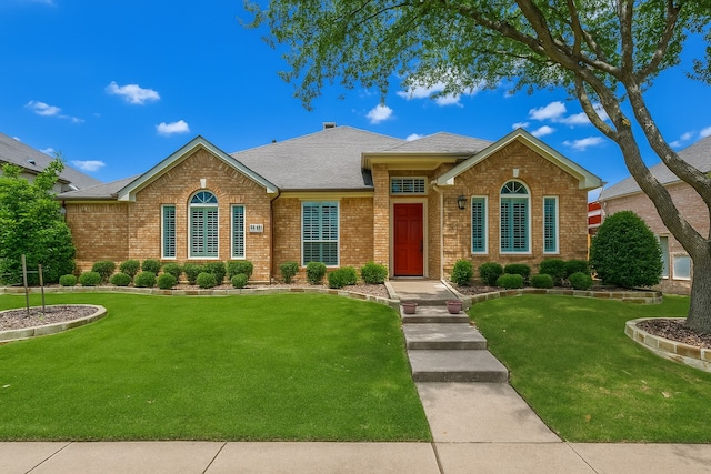 7491 Daffodil Way, Frisco, TX 75033 - view of front facade with brick siding, a front lawn, and roof with shingles