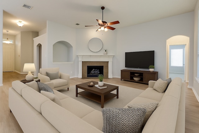 7491 Daffodil Way, Frisco, TX 75033 - living area featuring ceiling fan, light wood finished floors, a fireplace, and baseboards