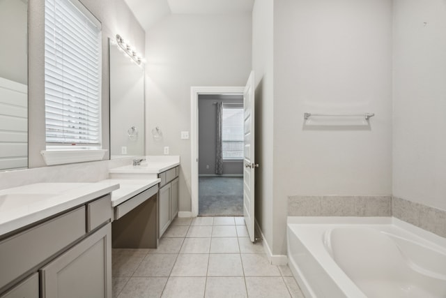 1529 Calcot Ln, Forney, TX 75126 - bathroom featuring vanity, a bath, tile patterned floors, lofted ceiling, and baseboards