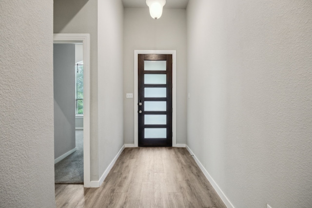 1529 Calcot Ln, Forney, TX 75126 - entrance foyer with wood finished floors, a textured wall, and baseboards