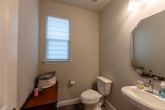 3036 Lionsgate Dr, Argyle, TX 76226 - bathroom with a sink, toilet, and baseboards
